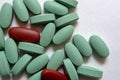 Close-up. Oval green and brown tablets on a white background Royalty Free Stock Photo