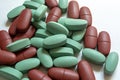 Close-up. Oval green and Brown tablets on a white background Royalty Free Stock Photo