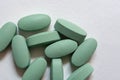 Close-up. Oval green tablets on a white background
