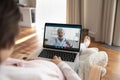 Pregnant woman have online call on laptop with doctor