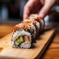 Various kinds of sushi served. Close-up of uramaki sushi rolls with red caviar, salmon, tuna, cucumber and avocado isolated on Royalty Free Stock Photo