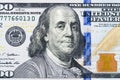 Close up overhead view of Benjamin Franklin face on 100 US dollar bill. US one hundred dollar bill closeup. Heap of one hundred