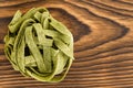 Close up on bundled ball of green fettuccini pasta