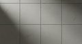 Textured Gray Square Tiles with Dramatic Light and Shadow Royalty Free Stock Photo