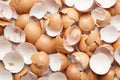 Close-up overhead view of numerous broken brown and white eggshells scattered randomly Royalty Free Stock Photo