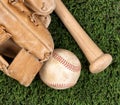 Close up overhead view of old baseball equipment on grass Royalty Free Stock Photo