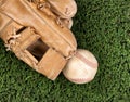Close up overhead view of old leather baseball and mitt on grass Royalty Free Stock Photo