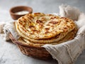 Golden Brown Layered Flatbread Stacked in Wicker Basket with Creamy Dip on Gray Surface Royalty Free Stock Photo