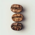 Three roasted coffee beans lined up on a light background Royalty Free Stock Photo