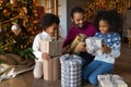 Close up overjoyed African American family unpacking Christmas gifts Royalty Free Stock Photo