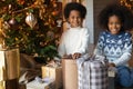 Close up overjoyed African American sister and brother unpacking gifts Royalty Free Stock Photo