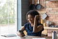 Close up overjoyed African American woman using phone, celebrating success Royalty Free Stock Photo