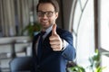 Close up overjoyed businessman wearing glasses showing thumbs up Royalty Free Stock Photo