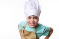 Smiling happy teenager boy - chef pastry, cook, baker confectioner wearing chef hat and beige apron, isolated on white