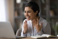 Close up overjoyed Indian woman looking at laptop screen