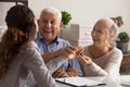 Close up overjoyed mature couple received keys, purchased new apartment