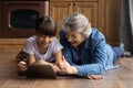 Close up overjoyed mature grandmother with granddaughter using tablet Royalty Free Stock Photo