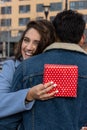 Close up overjoyed wife hugging husband, thanking for romantic present, surprise, happy attractive young woman holding gift box ,