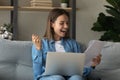 Close up overjoyed woman reading good news in paper letter