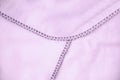 Close-up of an overlock seam on pink plaid. Home textiles Royalty Free Stock Photo
