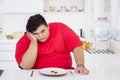 Overweight man looks unhappy to eat salad Royalty Free Stock Photo