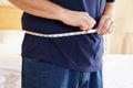 Close Up Of Overweight Man Measuring Waist Royalty Free Stock Photo