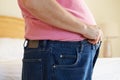 Close Up Of Overweight Man Trying To Fasten Trousers Royalty Free Stock Photo