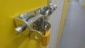 A close up of a padlock and door bolt on a self storage unit door