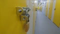 A close up of a padlock and the end of a storage unit corridor