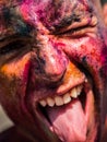 A close up of a painted man with his mouth open, doing silly face with tongue out Royalty Free Stock Photo