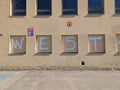 Close-up of a painted mural on the side of a building, the inscription reads "West"