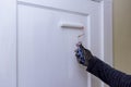 Close up of painter hands with gloves painting the door frame using hand roller Royalty Free Stock Photo