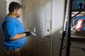 Close up of painter hands with gloves painting the door frame using hand roller Royalty Free Stock Photo