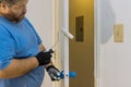 Close up of painter hands with gloves painting the door frame using hand roller Royalty Free Stock Photo