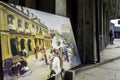 Close-up of a painting outside a store depicting a nostalgic street scene in the French Quarter