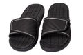 Close-up of a pair of black rubber sandals or slippers for the shower swimming pool or beach with slip-resistant outsole Isolated Royalty Free Stock Photo