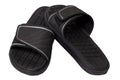 Close-up of a pair of black rubber sandals or slippers for the shower swimming pool or beach with slip-resistant outsole Isolated Royalty Free Stock Photo