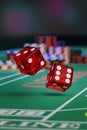 Close up of a pair of dice rolling down a craps table.Gambling concept. 3d illustration