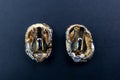 Close-up of a pair of gold earrings on a black background Royalty Free Stock Photo