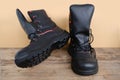 Close-up of pair of new black Safety Shoes, work boots made of leather with reinforced cape on old wooden boards, concept of Royalty Free Stock Photo