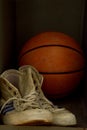 Old sport sneakers shoes and basketball ball Royalty Free Stock Photo