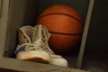 Old sport sneakers shoes and basketball ball Royalty Free Stock Photo