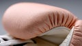 A close up of a pair of pink boxing gloves on a gray background Royalty Free Stock Photo