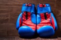 Close-up of the pair of red and blue boxing gloves on the wooden plank. Royalty Free Stock Photo