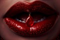 A close-up of a pair of red lips with water droplets and a red piercing hanging from the upper lip