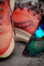 Close-up of a pair of red Saucony Endorphin Speed sneakers with a pair of sunglasses set on top