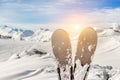 Close-up pair of skis on mountain winter resort with ski-lift and beautiful winter mountain panoramic scenic view Royalty Free Stock Photo