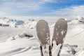 Close-up pair of skis on mountain winter resort with ski-lift and beautiful winter mountain panoramic scenic view Royalty Free Stock Photo