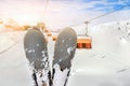 Close-up pair of skis on mountain winter resort with ski-lift and beautiful winter mountain panoramic scenic view Royalty Free Stock Photo