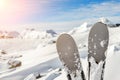 Close-up pair of skis on mountain winter resort with ski-lift and beautiful winter mountain panoramic scenic view Royalty Free Stock Photo